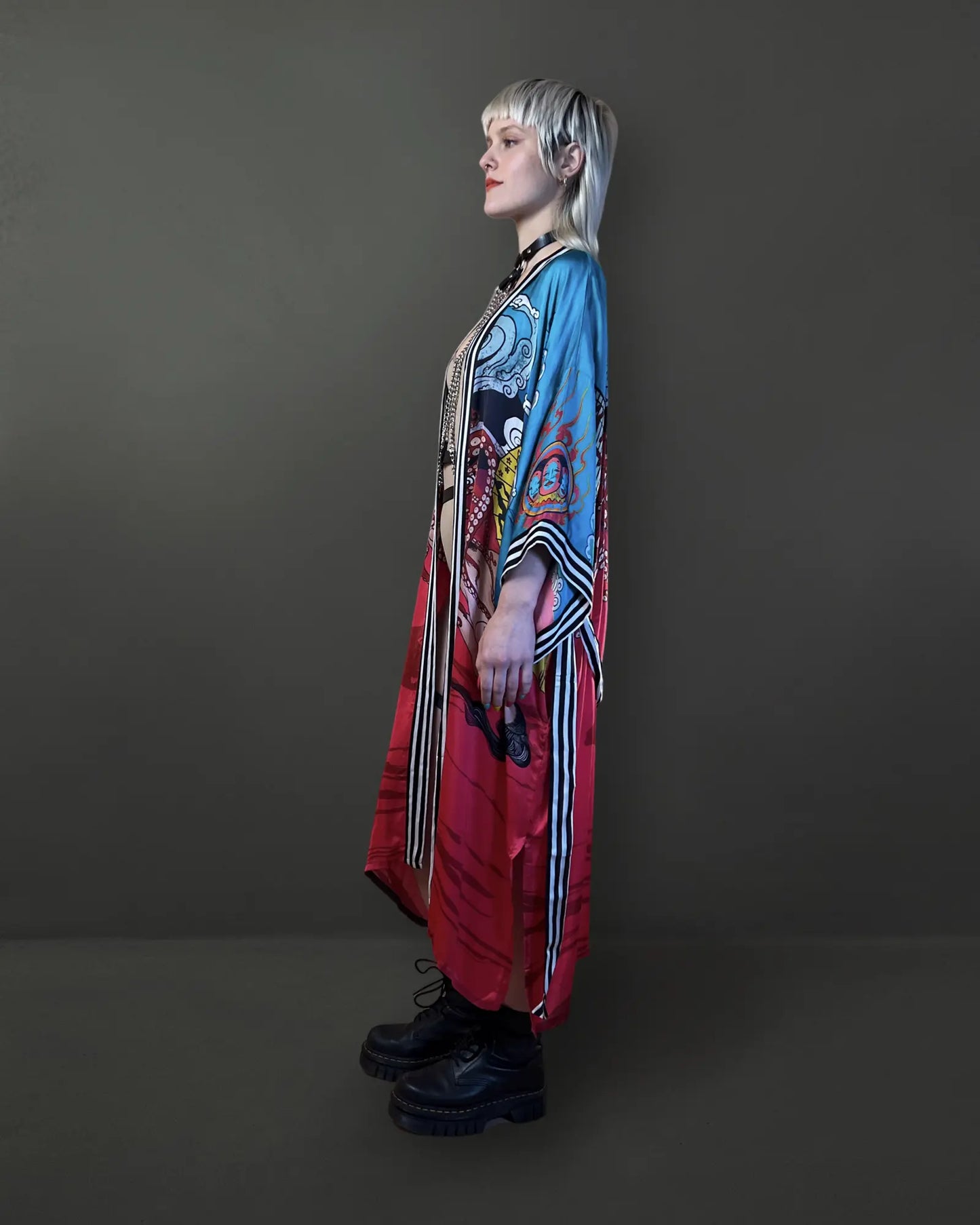 Side angle showing relaxed drape and functional pockets of the red artistic kimono