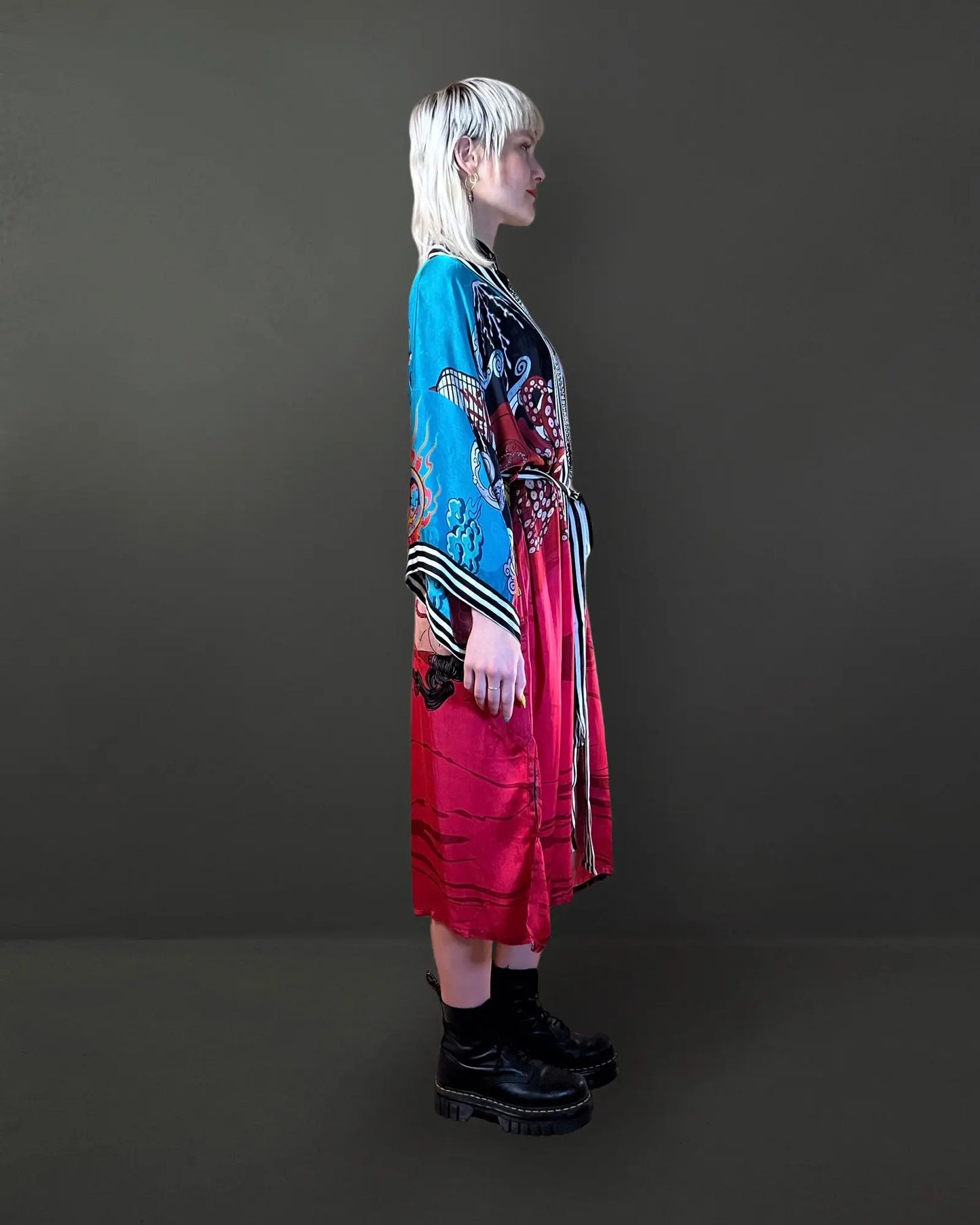 Side angle showing relaxed drape and functional pockets of the red artistic kimono